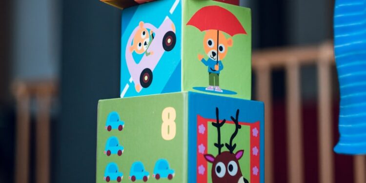 child building an four boxes