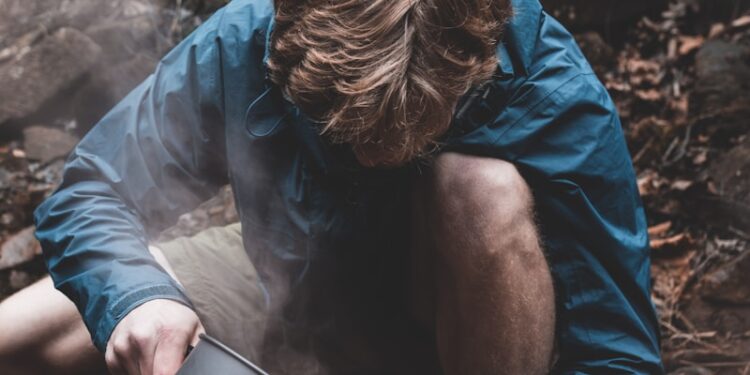 man pouring coffee on cup
